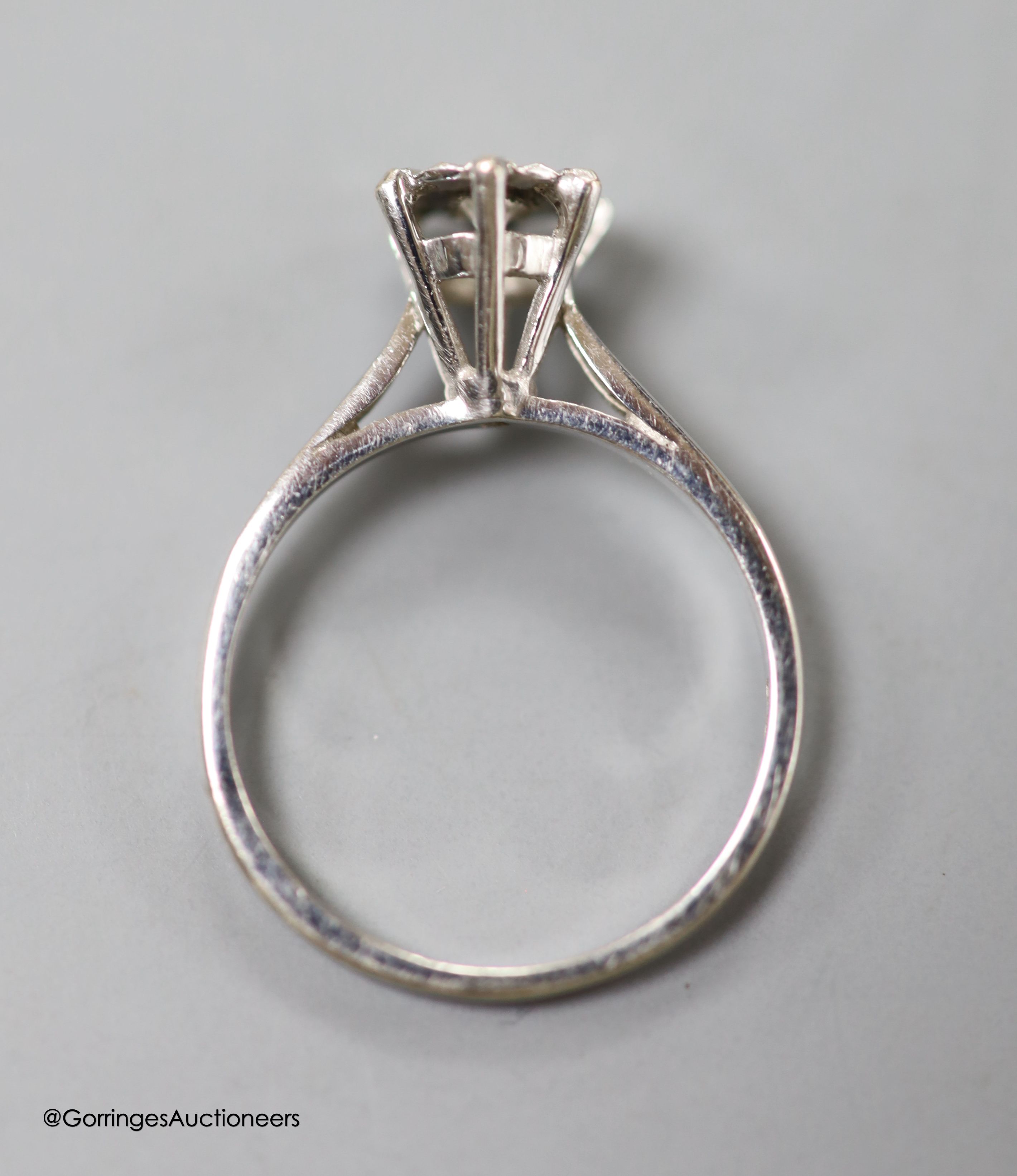 A modern 18ct white gold and illusion set solitaire diamond rig, size L/M, gross 2.4 grams.